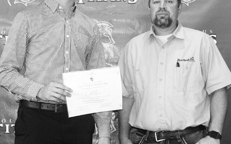 Cole Minor was awarded a $500 Heartland Lineman Scholarship from Heartland Manager of Operations, Dan Avery, during the Columbus Unified High School Senior Assembly, May 19, at the high school gymnasium.