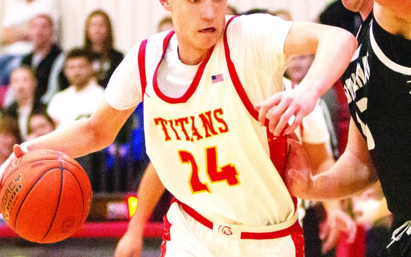 Kooper Saiz, Titan Sophomore, drives to the basket with a little push from his Frontenac defender in the January 31, home loss to the Raiders. The Titans lost a close one, 50-52, against St. Mary’s-Colgan, Friday in Pittsburg. Photo by Kristin Sharp.
