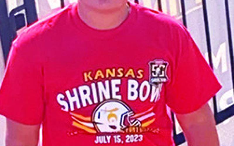 Columbus Titan Ethan Midgett has been ball boy and bat boy for his brother Landin’s ball teams for many years. Saturday was no different when the incoming CUHS Freshman was on the sideline serving as ball boy for the 50th Annual Kansas Shrine Bowl Game in Hays. Courtesy Photo.
