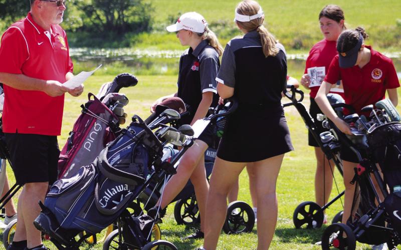 Lady Titan Golf Coach, Ernie Vaughn, meets with members of his team prior to tee off at the Columbus Invitational Golf Tournament, Thursday, at the Brush Creek Golf Course in Columbus. The Lady Titan held off St. Mary’s-Colgan for the one stroke win. Mallory Thompson, Anna Head, Jaiden Campbell, and Natalie Wary prepare for the day.
