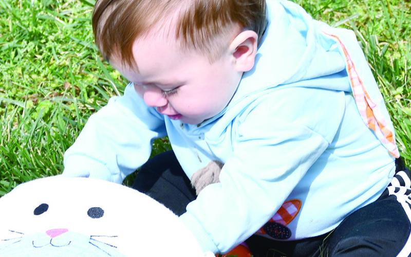 George Sturdy seemed to be more interested in what was already inside his basket as opposed to searching for eggs at the Baxter Springs Kiwanis Easter egg hunt Saturday.