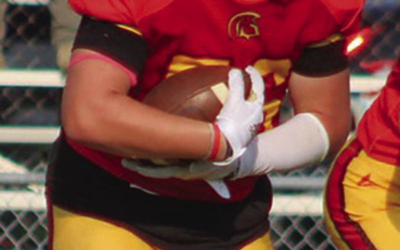 Titan Eighth Grader, Kash Smith, punched through the line for a one-yard touchdown, Thursday, at Girard. Columbus took a 32-20 win over the Trojans in the CCCJL contest.