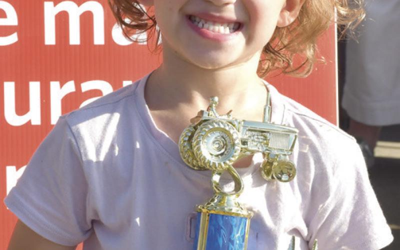 At right, out of town contestant Brynleigh Lyman of Iowa, was the lone entrant in the 4 year old age group. She pulled a distance of 1’4”. First place winners are eligible to attend the state pedal tractor pull.