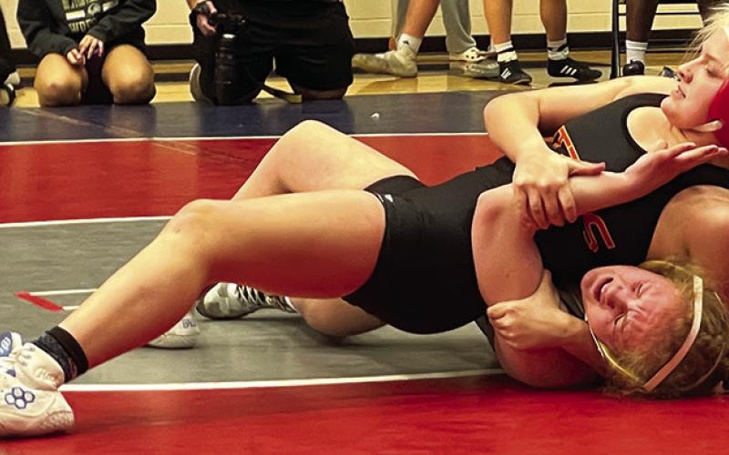 Emily Britt, Lady TItan Junior, pins her opponent during action at the Bentonville West High School Tournament, Friday, in Centerton, Ark. Emily placed third in the 135-pound weight class Photo courtesy of Amanda Stone.