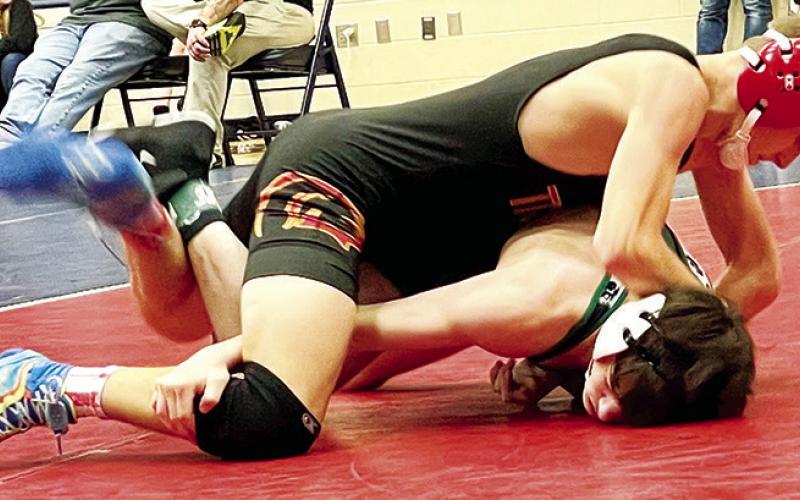 Titan Junior, Korbyn Newberry, works for a pin in the championship match of the 120-pound weight class on his way to the title at Bentonville West HIgh School, Saturday, in Certerton, Ark. Photo courtesy of Amanda Stone.