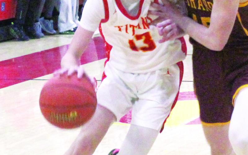 Titan Sophomore Point Guard, Carter Woodcock, makes his way to the basket with the “aide” of Girard Sophomore, Perrin Stevens, during the Columbus varsity loss to the Trojans, Tuesday, at the CUHS Gymnasium. Carter had 15 points in the 54-52 loss to Colgan, February 7 in Pittsburg.