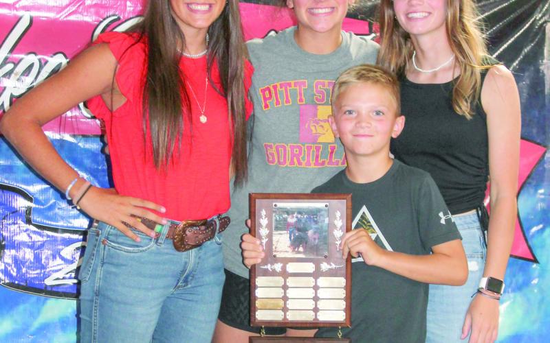 Brylie Johnson, Lone Elm Beavers was presented with the Justin Mooney Memorial Award during awards night of the Cherokee County Fair. The Mooney Family Katy, Lily and Jase, presented the award.