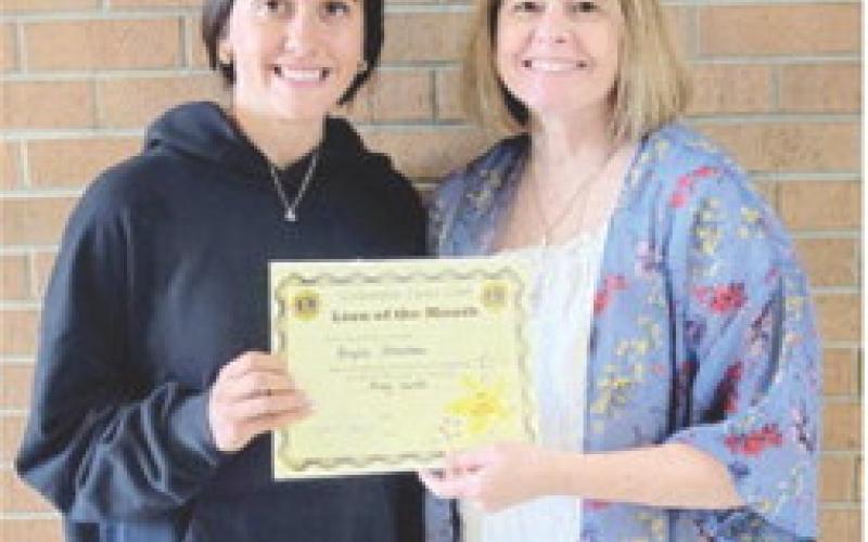 Brylie Johnson was recently presented a certificate recognizing her as the Lion of the Month for May. Regina Jameson presented the award.