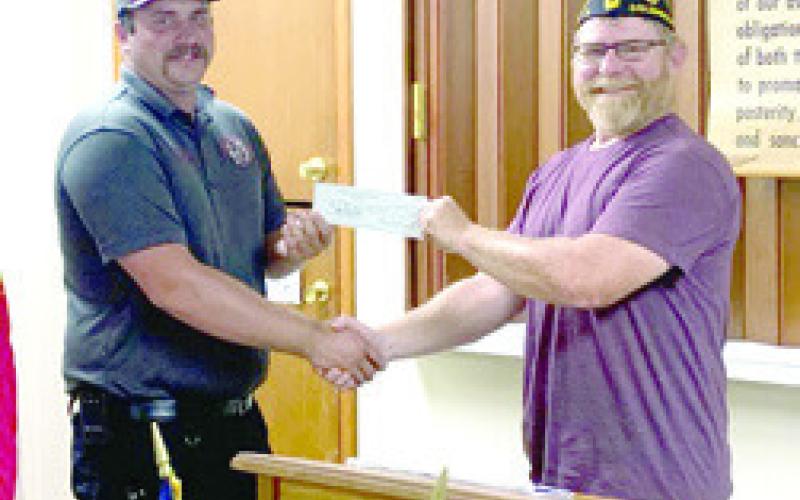 Columbus Firefighter Dylan Koehler accepted a $500 donation from American Legion Commander Aron Davolt at a recent Legion meeting. The donation will be used to help support the upcoming Freedom Fest celebration July 8.