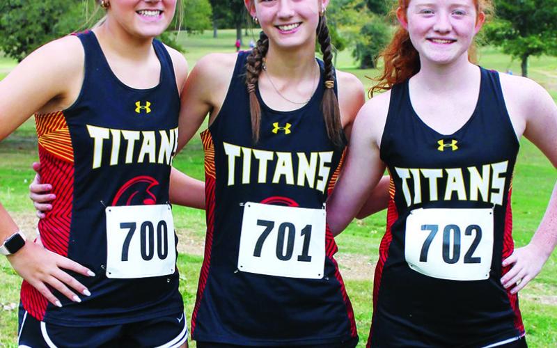 Lady Titans Kenadie Carter, Darcy Garett, and Kennedy Riechardt and the Titan Cross Country Team hosted the CNC League Cross Country Meet, at the Brush Creek Golf Course, October 12.