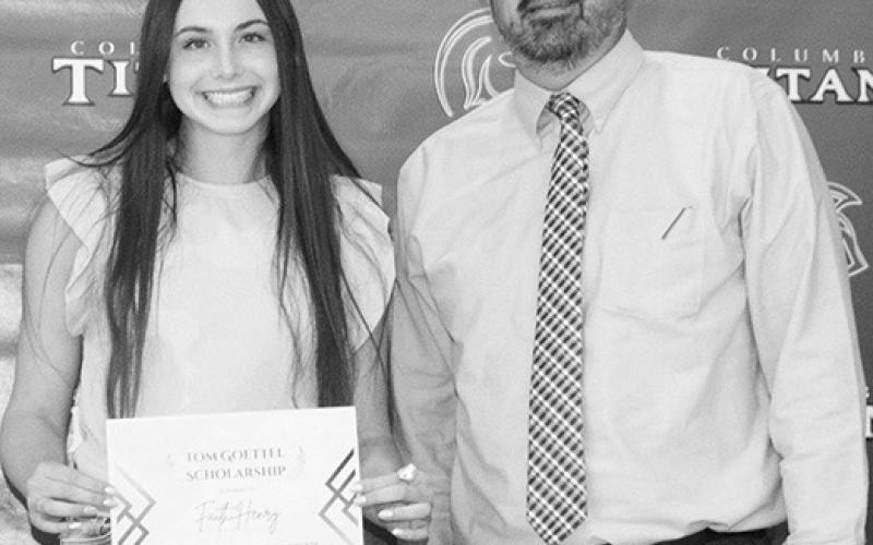 Faith Henry received the Tom Goettel Scholarship in the amount of $1,000 from Columbus Unified High School Principal, Dan Grundy at the May 18, Senior Assembly held at the CUHS Gymnasium.