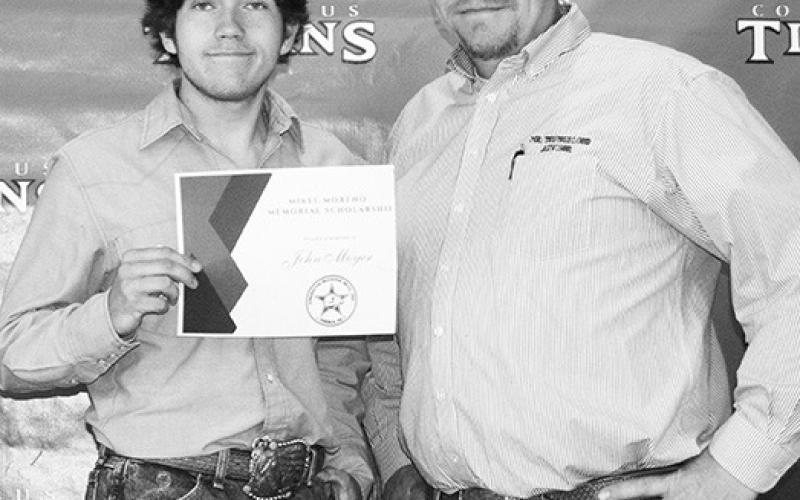 John Moyer received the Mikel Moreno Memorial Scholarship from CUHS Ag Instructor, K.C. Youngblood in the amount of $4,500 at the Senior Assembly, May 18, at the Columbus High School Gymnasium.