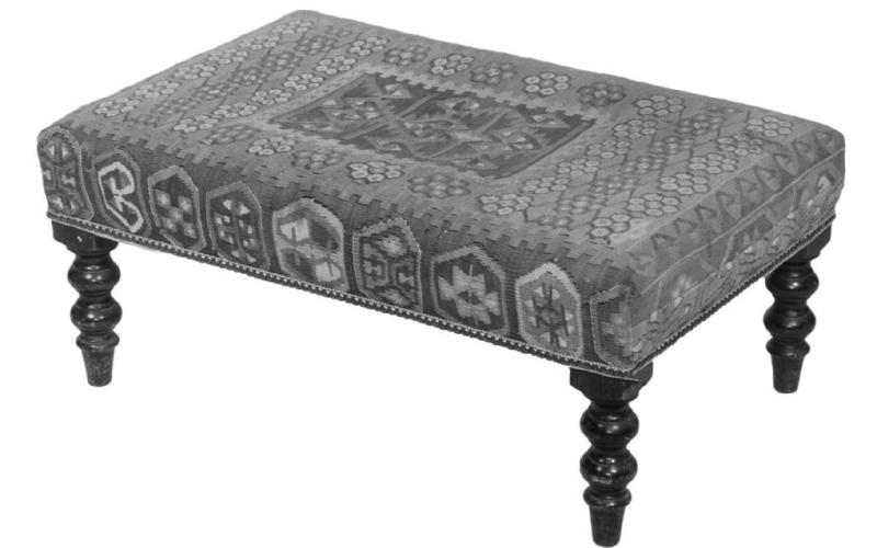 Rugs aren’t just for covering the floor. An antique kilim rug, a style originating in Western Asia, found another life as upholstery for a 20th-century bench. Photo Credit: Thomaston Place Auction Galleries (c) 2025 by Cowles Syndicate Inc.