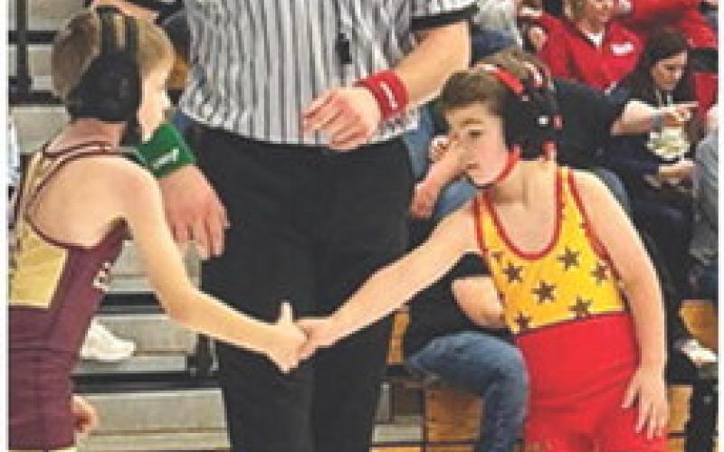 Rhett Tedlock shakes the hand of his opponent after getting a win during the Marshfield, Mo., Holiday Championship Tournament, Saturday. Rhett also wrestled in Erie Red Devil Tournament, December 17. The Columbus Wrestling Club will be in Anderson, Mo. tomorrow. Courtesy Photo.