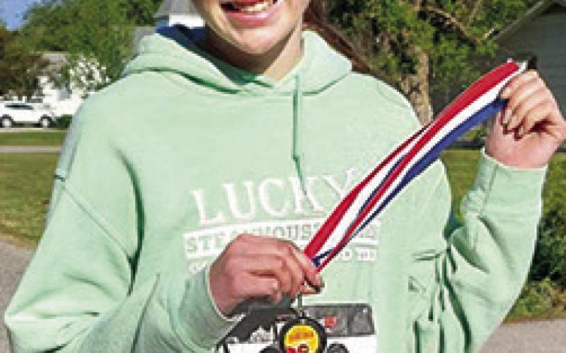 Sammi Ohmart (left) was the winner of the 13U girls division of the Columbus Lady Titan Volleyball Fundraiser 5K Run, April 20. Samie ran a time of 34:28 minutes to take first place. Additional winners will be recognized in a later edition of the News-Report. Courtesy photo.