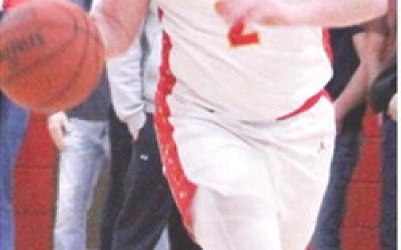 Titan Senior, Jett Tanner, brings the ball up court during the loss to Riverton, 49-55, Tuesday, at the CUHS Gym. Jett scored nine points in the loss for the Titans.