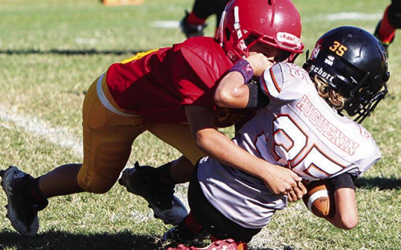 Briggs Johnson makes a tackle in the backfield during the Titan 3rd/4th Grade loss to Independence, 8-22, Saturday at Titan Stadium. Photo by Kristin Sharp.
