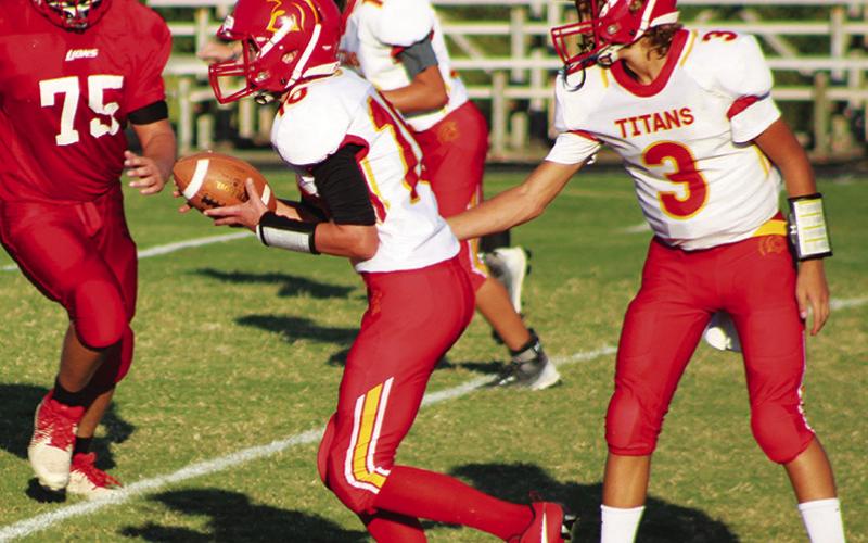 Titan Eighth Grade Quarterback, Cole Howard, hands off to running back/wide receiver, Brody Carter, for a nice gain in the Thursday game at Baxter Springs. Howard scored two rushing touchdowns and hit Carter for a touchdown pass play in the 22-20 win over their host.