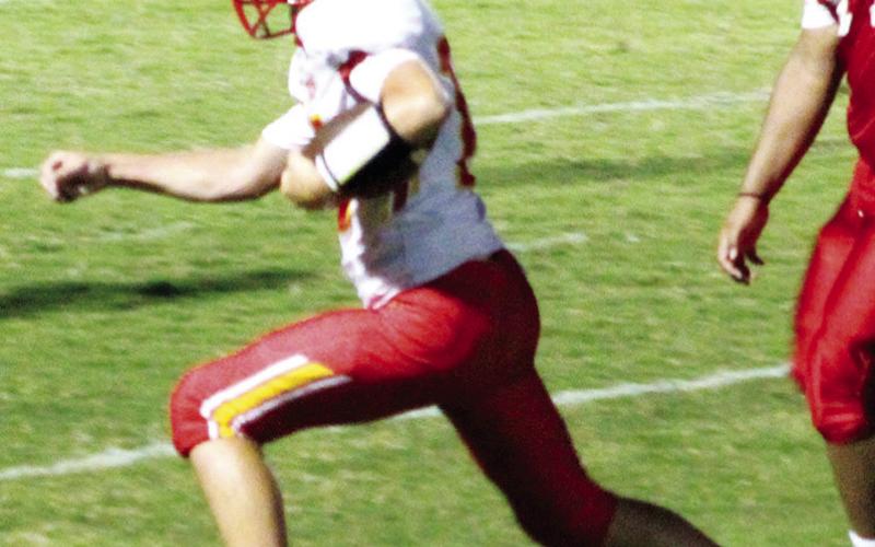 Columbus Titan Seventh Grade Quarterback, Jace Gaither, sprints 14 yards past the Baxter Springs defense to score six points in the 34-6, Columbus win in Baxter Springs, Thursday.