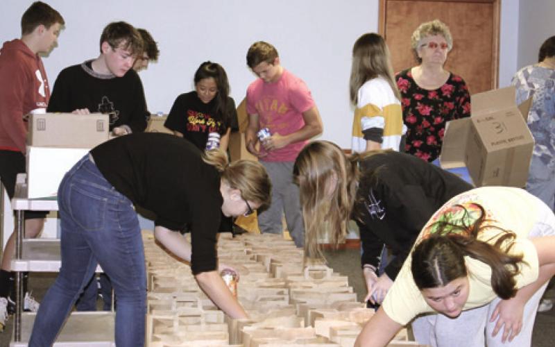 Community members, students assemble Thanksgiving food boxes