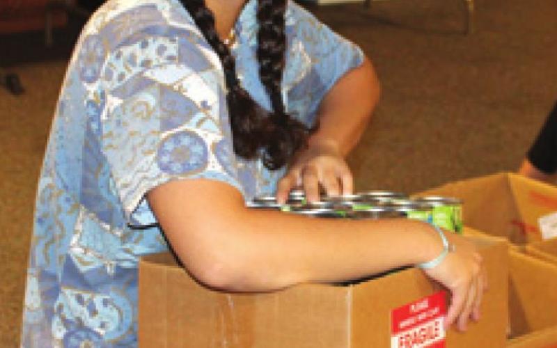 Community members, students assemble Thanksgiving food boxes