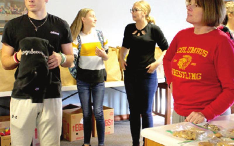 Community members, students assemble Thanksgiving food boxes