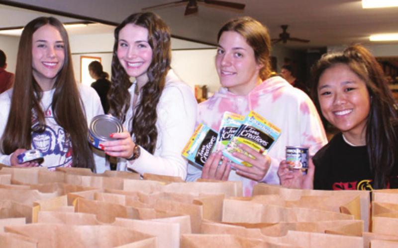 Community members, students assemble Thanksgiving food boxes