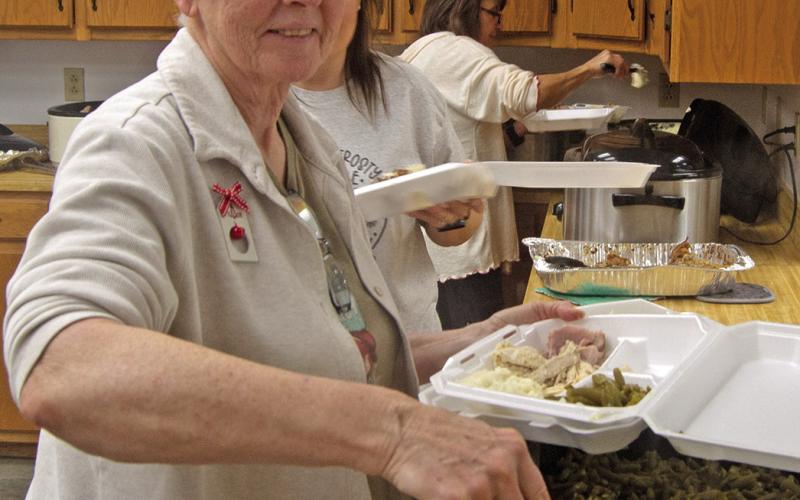 Dipping green beans kept Debbie Messer busy Saturday morning first in the to go orders then serving those present at the Annual Community dinner.