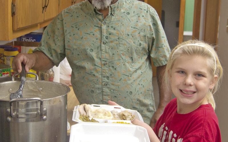 The last thing on the plate is Bill Jones’ “famous” gravy dipped hot from the kettle. Volunteer Rylie Oehme was carrying the to go orders to each of the servers before passing the dish to the delivery volunteers.