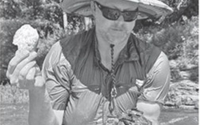 Pittsburg State University biologist James Whitney finds a dead mussel’s shell while sifting through rocks in the Spring River. Celia Llopis-Jepsen/ Kansas News Service