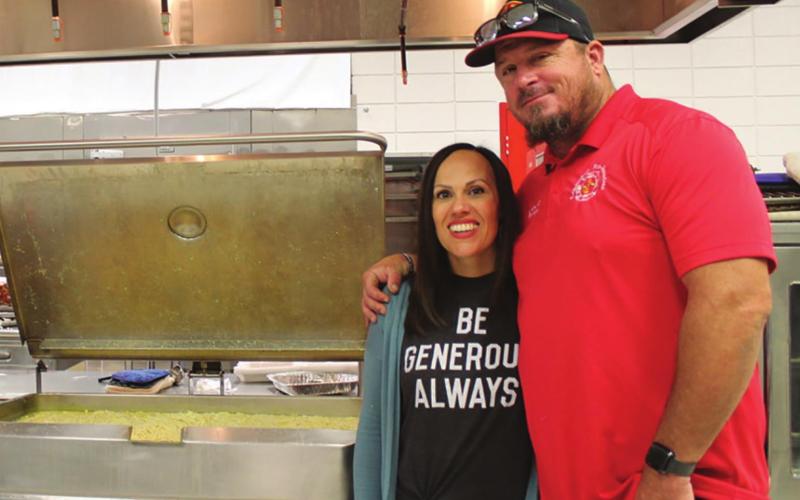 Leslie Minor and her husband, Columbus Firefighter, James Minor, help serve Chicken and Noodles at the Malachi Brown fundraiser in Baxter Springs. Over 700 meals were served.