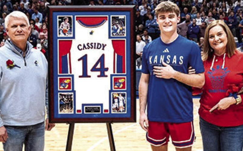 Patrick Cassidy and his parents Jeff and Julie Cassidy during the Kansas University Senior Night Ceremonies, Tuesday, at Allen Fieldhouse in Lawrence. The academic senior will use his available eligibility to continue his career with the Jayhawks next season. (Courtesy Photo.)