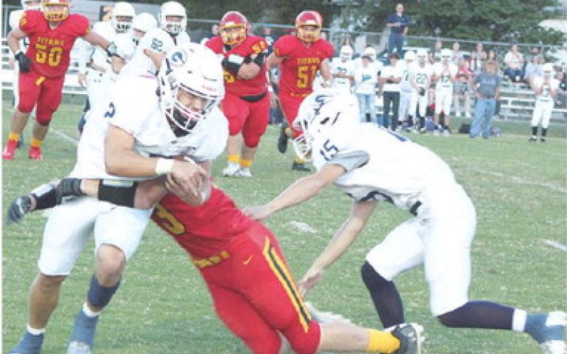 Titan Junior, Korbyn Newberry, takes down Galena Senior Zane Turner, in the backfield as a host of Titans converge on the play. Bulldog Junior, Kota Dannels, tries to assist Turner to no avail. Columbus earned their first win over Galena, 12-8, Friday night at Titan Stadium.