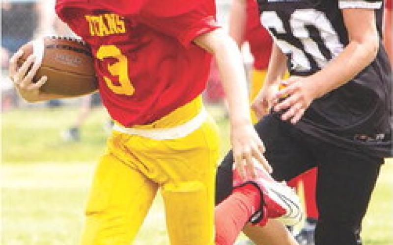 Columbus Mini Titan, Bodie Saiz, broke tackles as he scored the final touchdown of the third and fourth grade Titan win over Frontenac, 30-0, at Titan Stadium, Saturday. Photo courtesy Kristin Sharp.