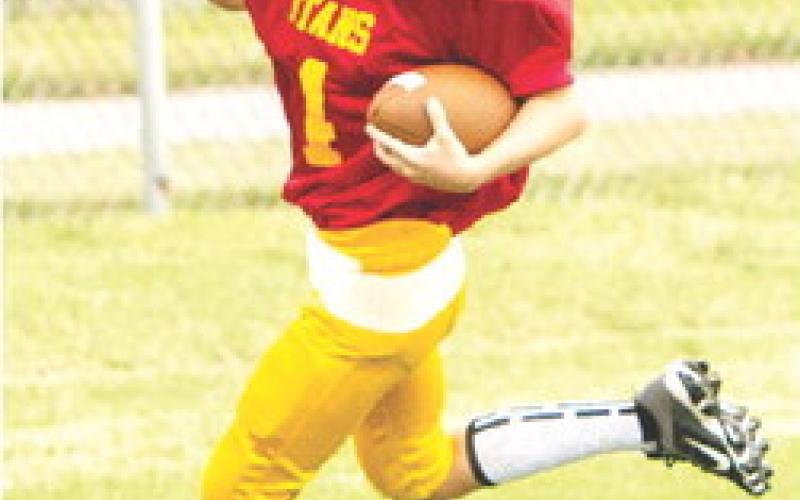 Dayton Hughes crosses the goal line for one of his many touchdowns in the Columbus Third and Fourth Grade Titan win over Frontenac, 30-0, Saturday at Titan Stadium. Photo courtesy Kristin Sharp.