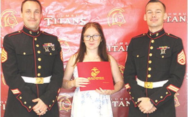 Athena Verren received recognition as a United States Marine Corps enlistee from Staff Sargent Brock, USMC and Staff Sargent Porter, USMC, during the Columbus Unified High School Senior Assembly, May 15, at the CUHS Gymnasium. Athena plans to be a motor transport operator.