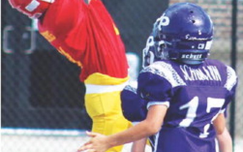 Titan Third and Fourth Grader, John Parsons, hauled in a tipped pass from team mate, Briggs Johnson, to score a rare passing, two-point conversion, in the Columbus Mini Titan shutout win over Pittsburg Ryan, Saturday, at Hutchinson Field, 22-0. Columbus will host Parsons in a pivotal match-up, Saturday at Titan Stadium. Kickoff is at 10 a.m. Courtesy Photo.