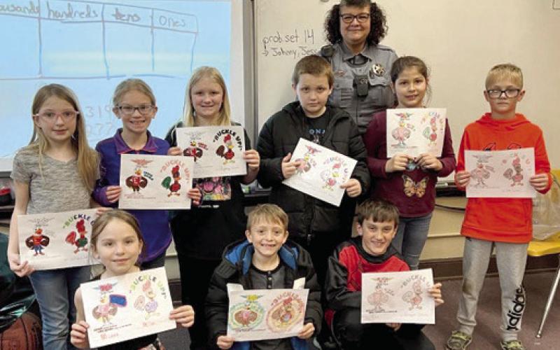 In January, the elementary schools had a Character Education and talked about Eddie Eagle on gun safety, Rooster Booster on car seats and seatbelts, ALICE training on active shooter. The students had a coloring contest for Eddie Eagle, and Rooster Booster. Bryar Dunham was the winner in Matthew Leet’s first grade class. Deputy Anne Sharp led the training classes. Courtesy photo.