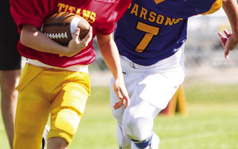 Mini Titan Dayton Hughes scored two touchdowns in Saturday’s third and fourth grade loss to Parsons, 12-26, at Titan Stadium. Photo by Kristin Sharp.