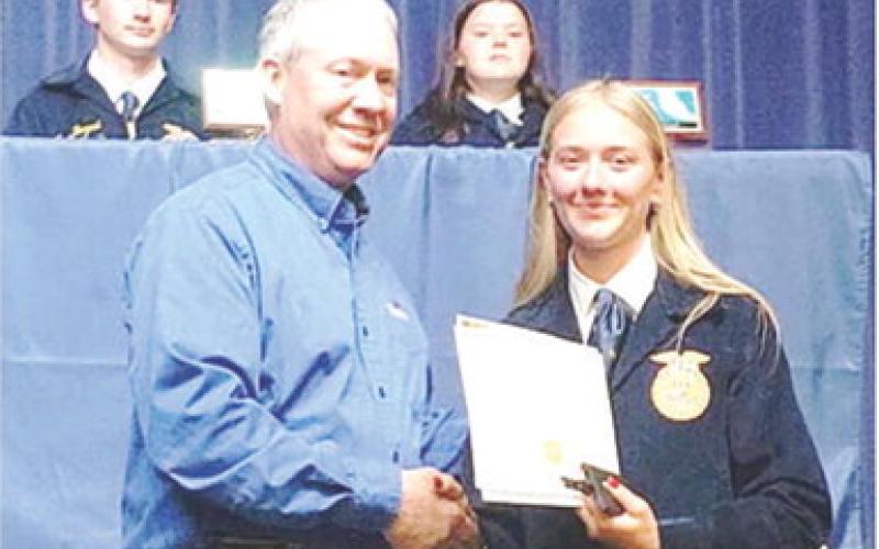 Southeast FFA senior, Kendyl Renn, was presented the FFA senior appreciation award from Dr. Kurtis Gregory, Cherokee County Farm Bureau representative at a recent ceremony. Courtesy photo.
