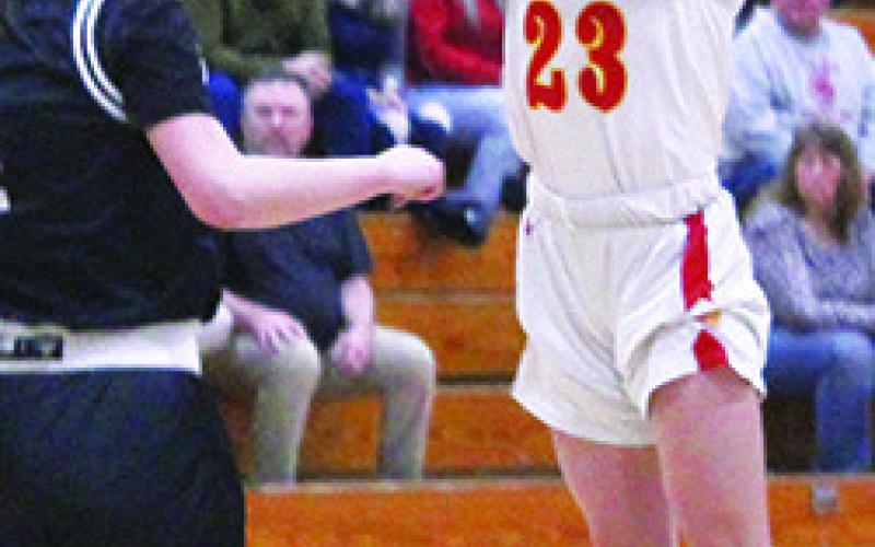 Lady Titan Senior, Katie Simpson, shoots over the Frontenac Senior, Ruth Frederick, in the Kansas Class 3A Sub-State win, 47-36, Tuesday, at the CUHS Gym. Last week, Katie was wrestling in the 4-1A State Wrestling Tournament in Salina.
