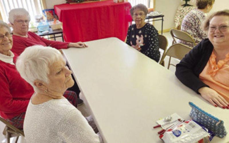 Getting ready for Bunco, Gail Houser, Geneva Grubbs, Rosaile Petersen, June Holcomb and Joanna Richards were among those attending the Christmas potluck and pajama party December 12.