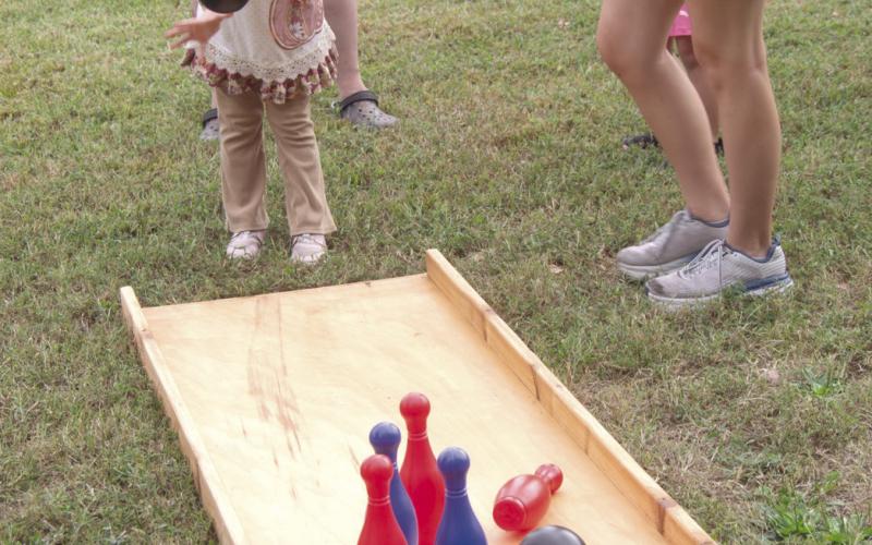 Lawn bowling can be intimidating for youngsters such as Abagale Harvey as she does her best to knock down the pins. The game was one of many games at Scammon Fall Festival.