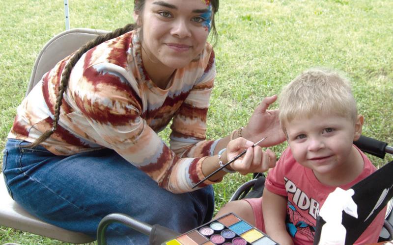 Face painter Kasandra Lopez painted a unique design on the face of a very still youngster Madden Madl.