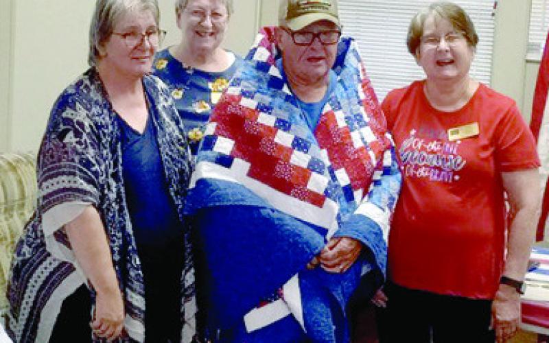 A Quilt of Valor was presented to Thomas Mounce of Miami, Okla., by Creating Quilts of Valor. at the monthly meeting of the Baxter Springs American Legion Post 206 September 13. Mounce served in the Army from 1969-1989, with duty stations including Vietnam, three tours Germany, and Fort Sill and Fort Hood. Courtesy photo.