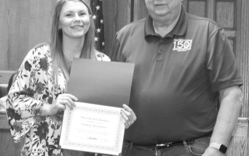 Former Columbus City Council member Lindsey Shoemaker is moving out of her district and resigning her council post. Mayor Grant Spieth presented Shoemaker with a certificate of appreciation for her work on the council.