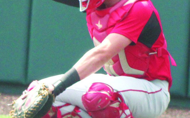 Columbus 2023 Graduate, Landin Midgett, signals his teammates from behind home plate in the Kansas Class 3A State Championship Quarterfinal win over Kansas City-Bishop Ward, May 25, at Kansas State University’s Tointon Family Stadium.