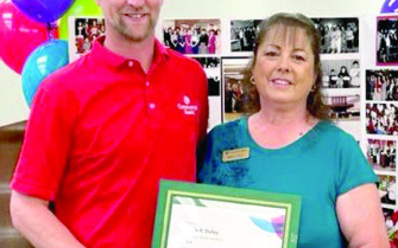 Wade Schossow presented Sonja Duley a certificat in recognition of her 40 years with Commerce Bank at a reception Friday. Courtesy photo.