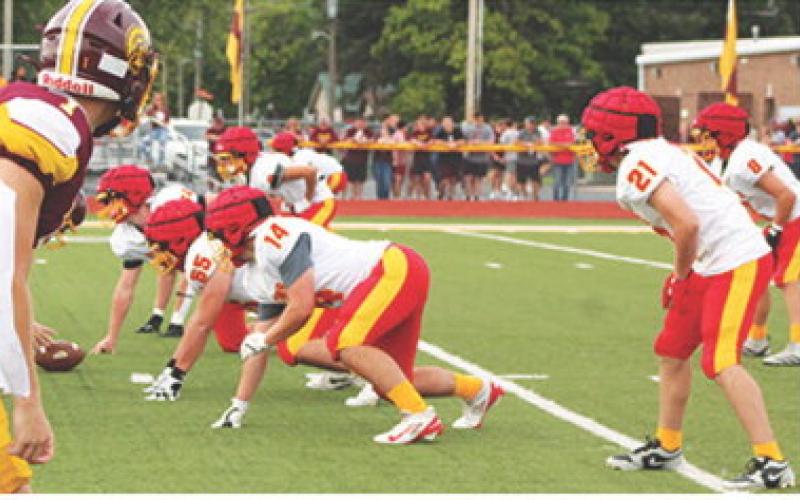 The Titan Defense set up against the Girard Offense in the first series of the four-team Jamboree scrimmage, Friday in Girard. Columbus varsity and junior varsity ran plays against their hosts as well as squads from Parsons and Pittsburg.