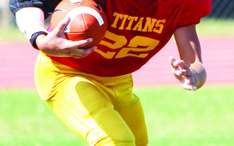 Blaze Bowman scored on a 35-yard run, a punt return, an interception return, and a pass play in the Columbus Fifth and Sixth Grade Titan win, 30-6, in Oswego, September 23. Photo by Kristin Sharp.